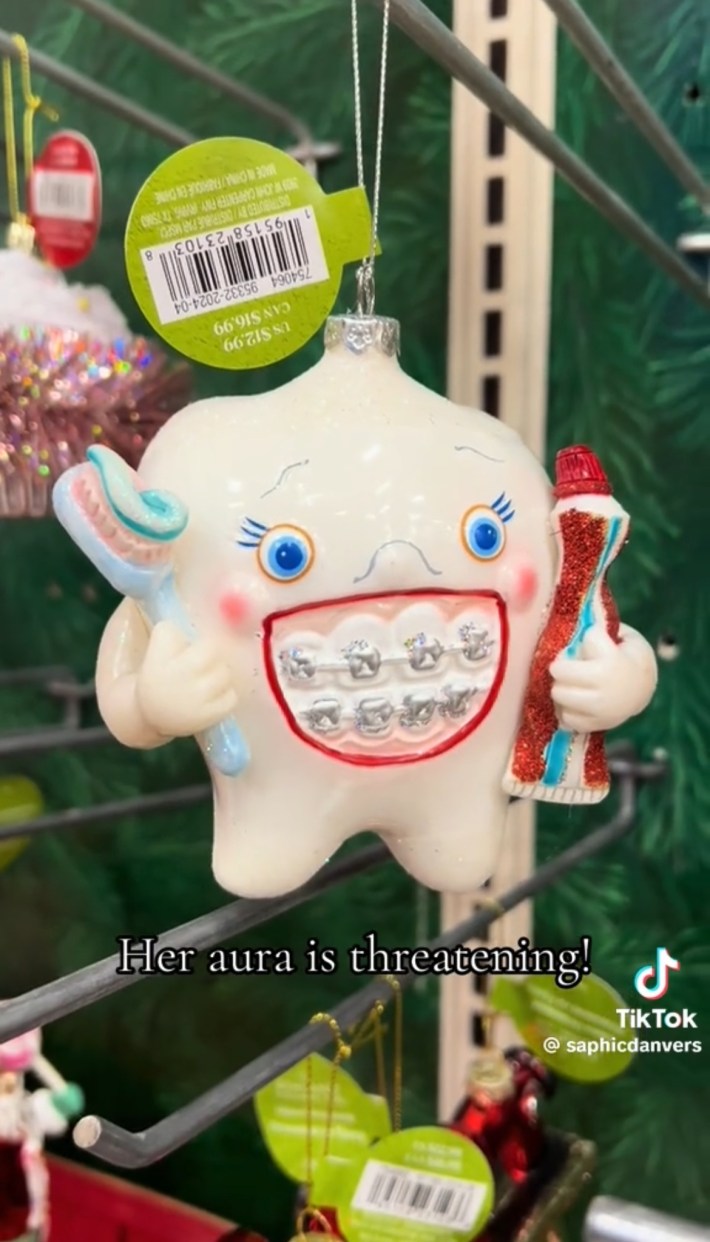 Smiling tooth with braces holding toothbrush and toothpaste