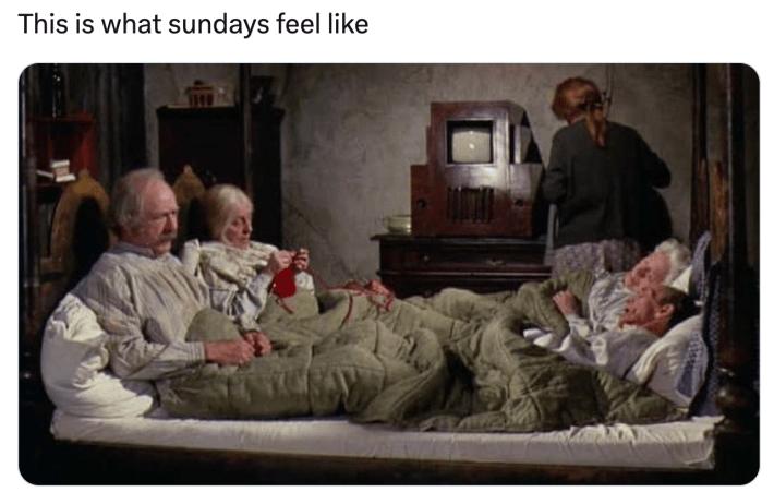Sunday meme that reads, "This is what sundays feel like" with a screencap from the beginning of Charlie and the Chocolate Factory of the four grandparents lying down in one bed.