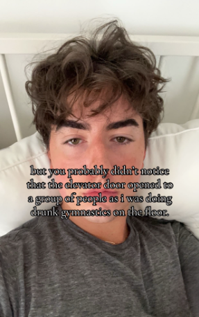 TikTok photo of a young man in bed staring blankly at the camera. Text overlay reads, "but you probably didn't notice that the elevator door opened to a group of people as i was doing drunk gymnastics on the floor."