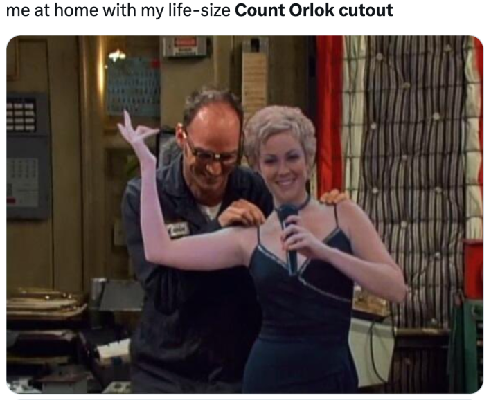 Nosferatu cardboard cutout meme, text reads, "me at home with my life-size Count Orlok cutout" and a photo of a man excited to have a cardboard cutout of a beautiful singer.