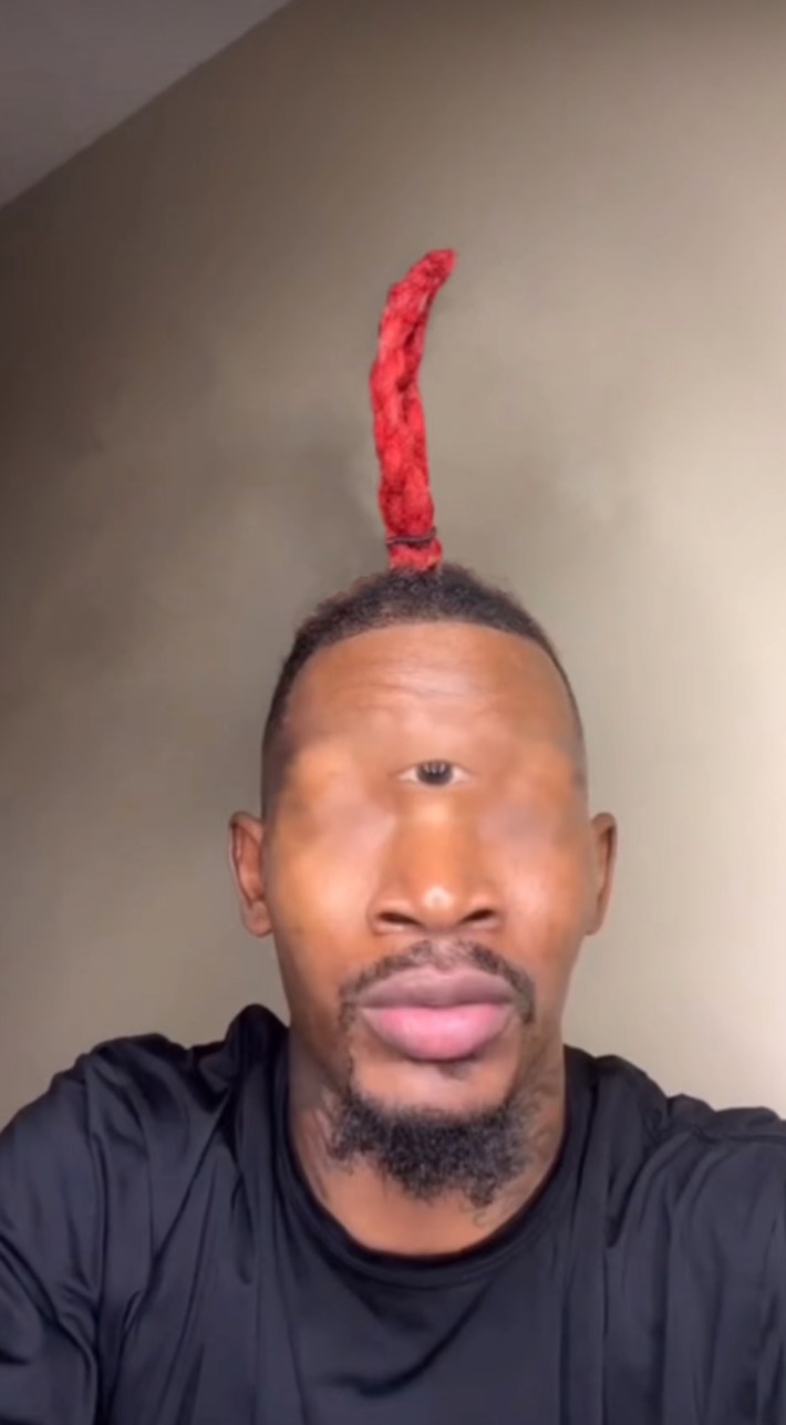 Eye of Rah meme edit with a Black man who only has one small eye in the middle of his forehead and one dread sticking up from his head.
