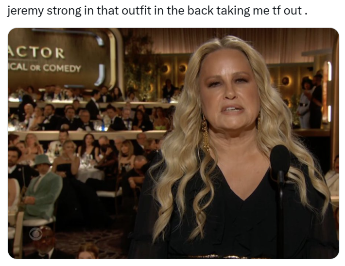 Golden Globes meme, text reads, "jeremy strong in that outfit in the back taking me tf out ." with a photo of Jennifer Coolidge looking confused while speaking into a microphone.