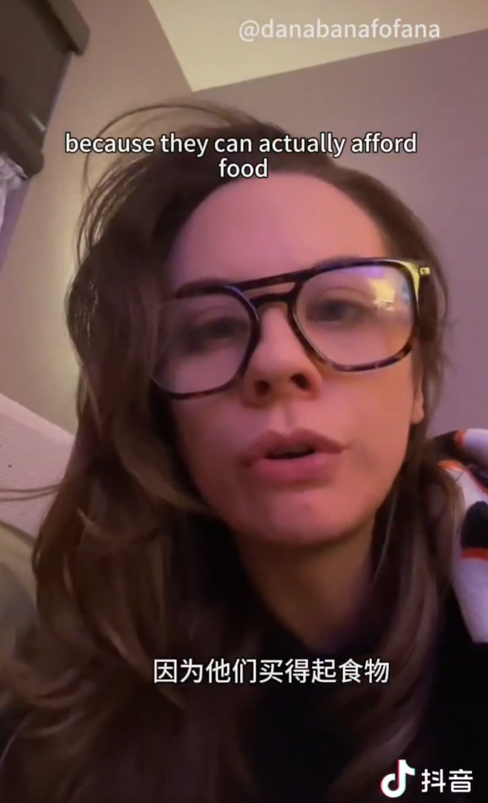 Screenshot from RedNote of a woman in large glasses talking about Chinese grocery hauls. Text overlay says, "because they can actually afford food."
