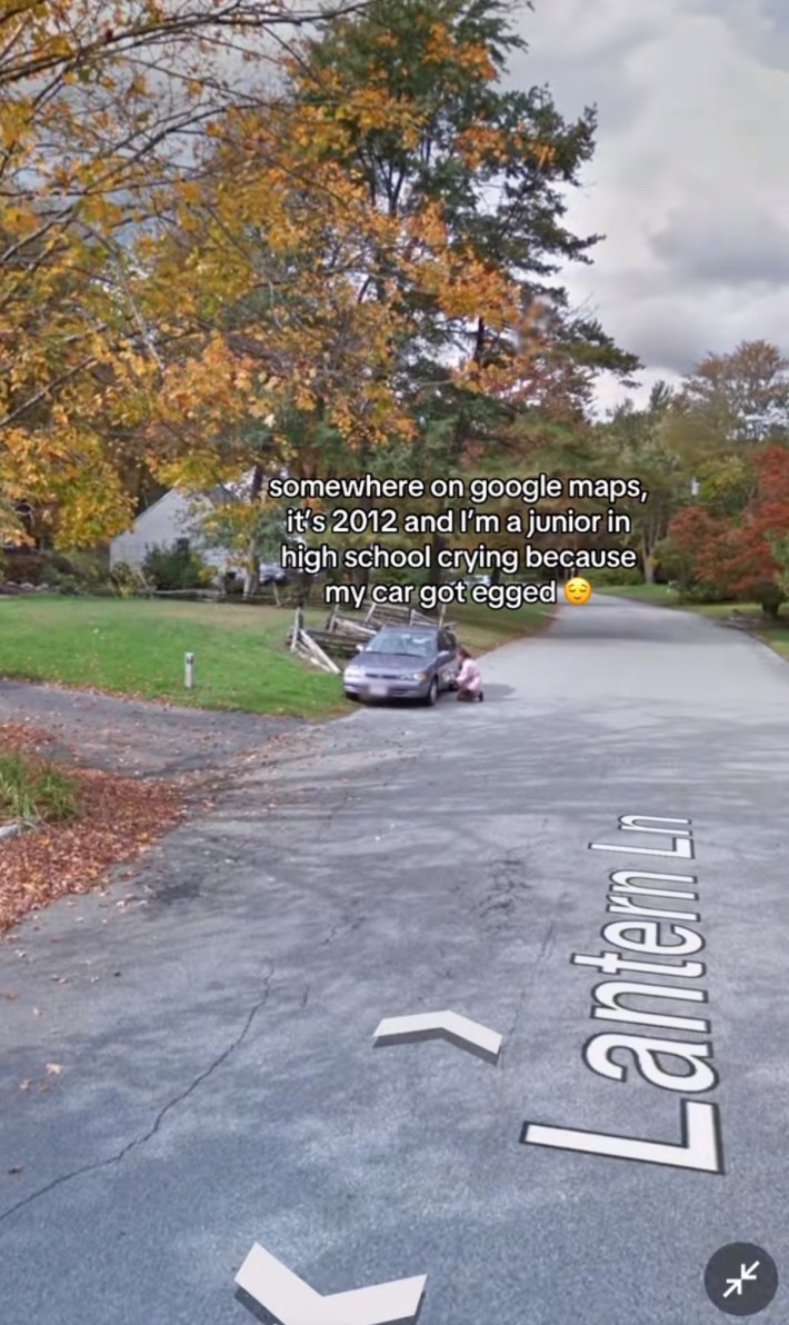 Somewhere on Google trend screenshot of a teenager kneeling next to her car. Text overlay reads, "Somewhere on Google maps, it's 2012 and I'm a junio in high school crying because my car got egged (smiley face emoji)"