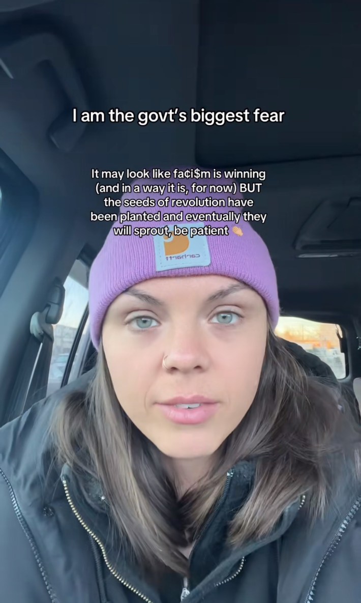 A woman in a pink beanie sitting in her car. Text overlay reads, "I am the govt's biggest fear."