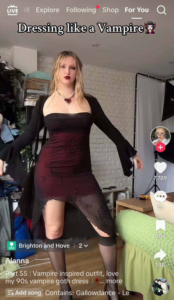 Woman in sheer black dress over red skirt