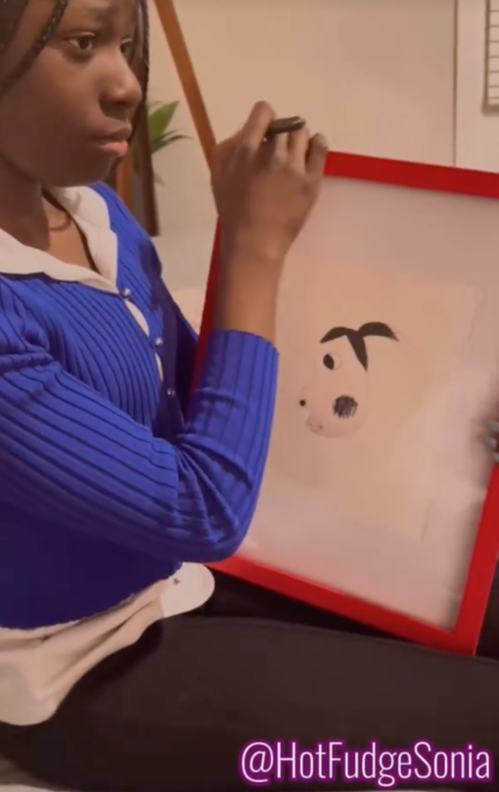 A photo of a daughter showing a very bad framed portrait to her mother.