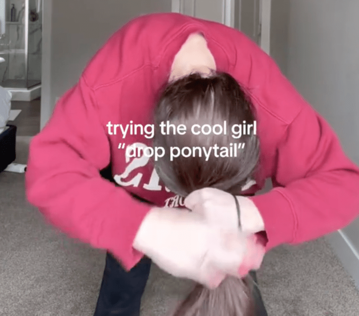 The "drop" part of "drop ponytail demonstrated in a TikTok video