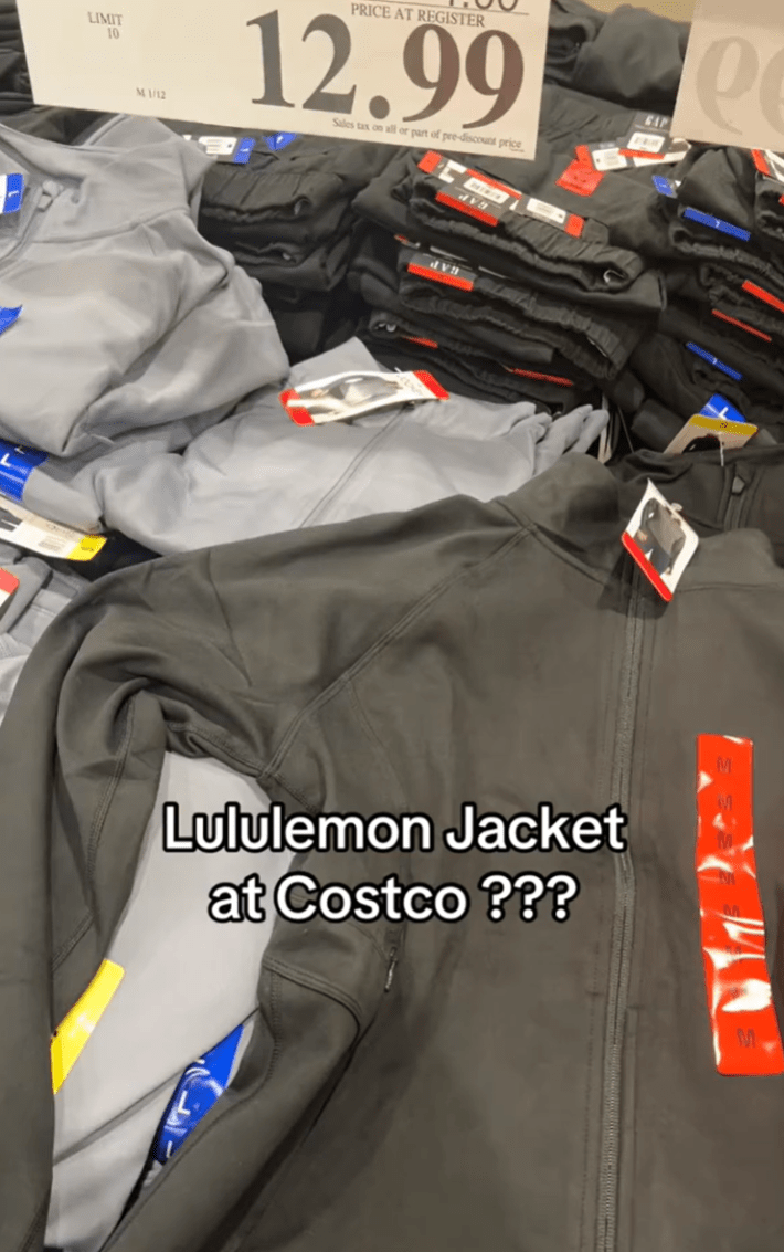 Still from a video in Costco showing off the Scuba dupes they have available for $12.99. Text overlay reads, "Lululemon Jacket at Costco???"