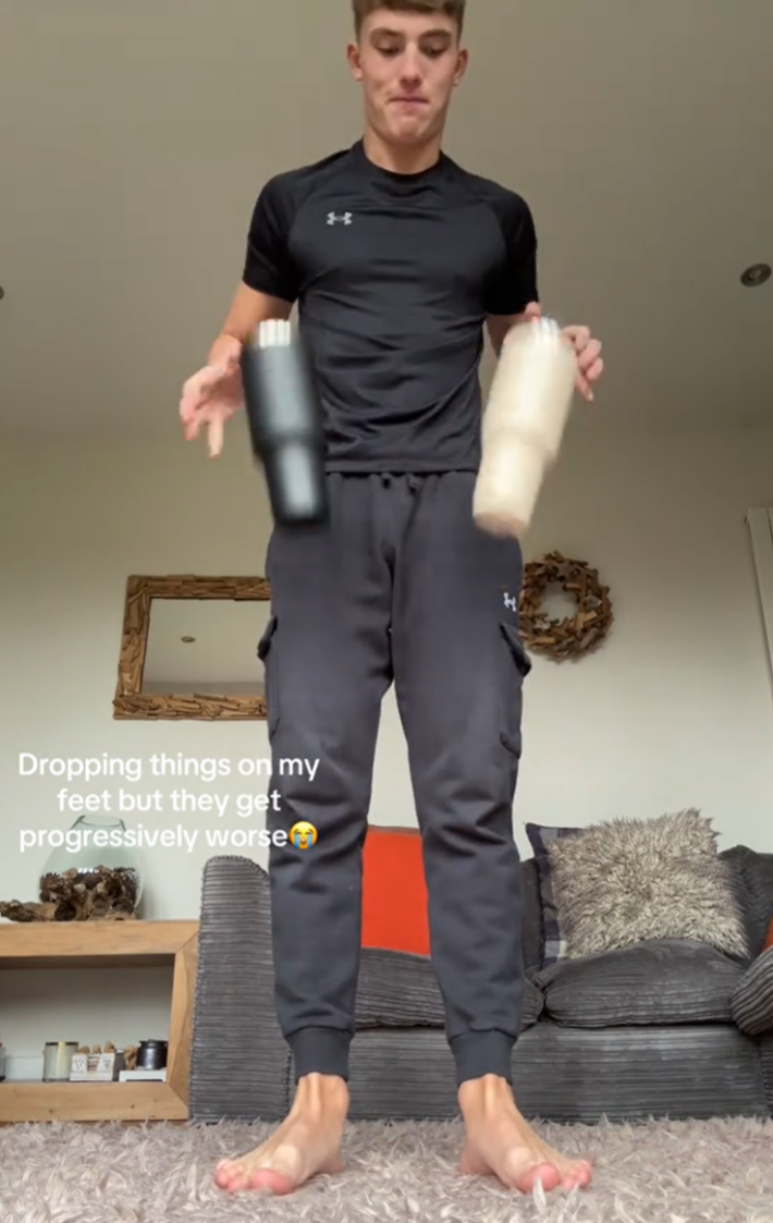 Dropping objects on feet TikTok trend, a man dropping Stanley cups on his feet.