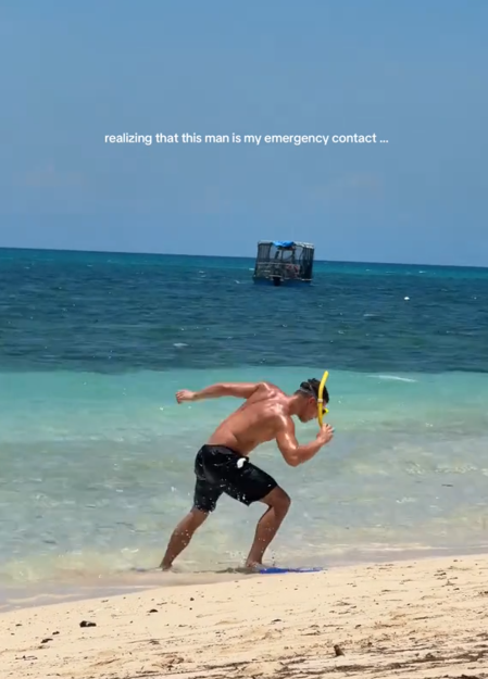Emergency contact trend TikTok video showing a man stumbling on a beach in snorkeling gear.