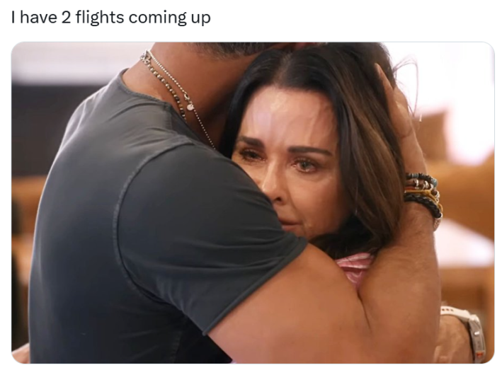 Plane crash meme, text reads, "I have 2 flights coming up" with a photo of a man holding a tearful woman in his arms.