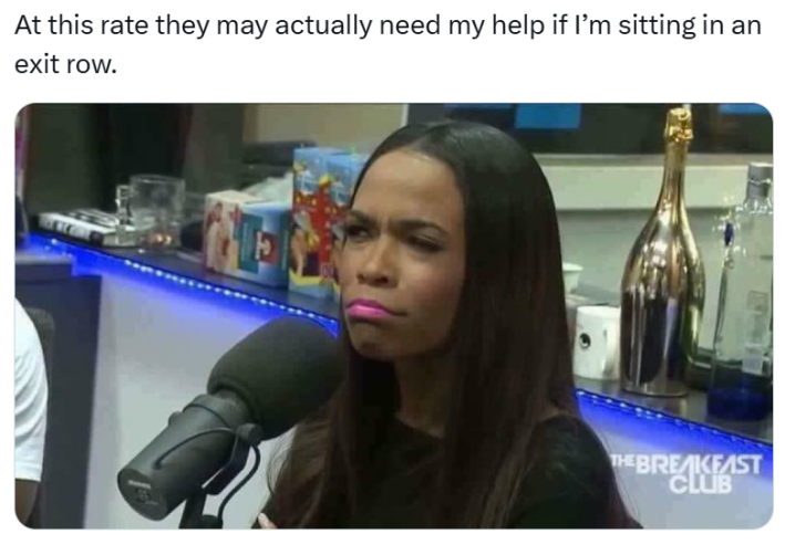 Plane crash meme, text reads, "At this rate they may actually need my help if I’m sitting in an exit row." with a photo of a woman at a mic looking unamused and concerned.