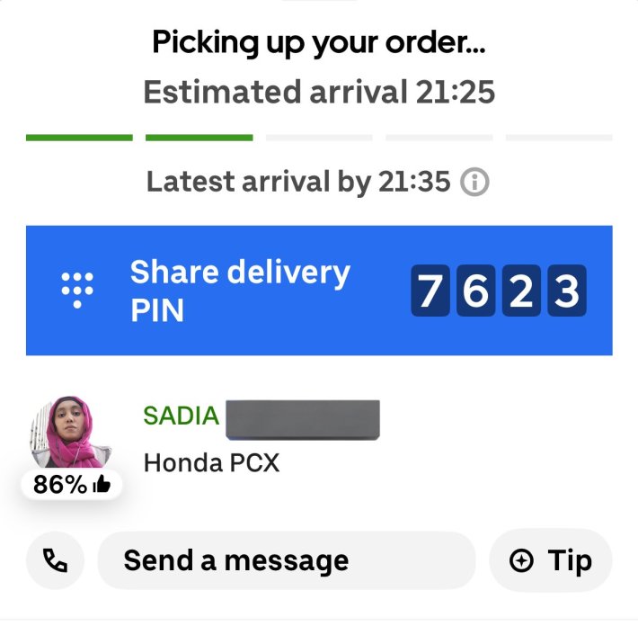 Screenshot of an Uber Eats app showing a female driver.