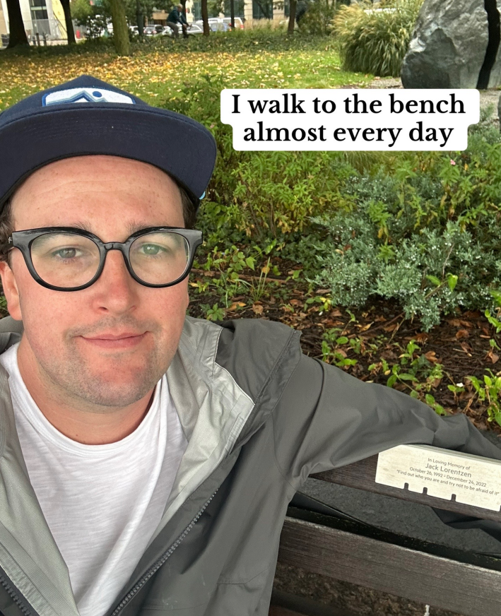 a photo of Jack sitting at his fiance's memorial bench.