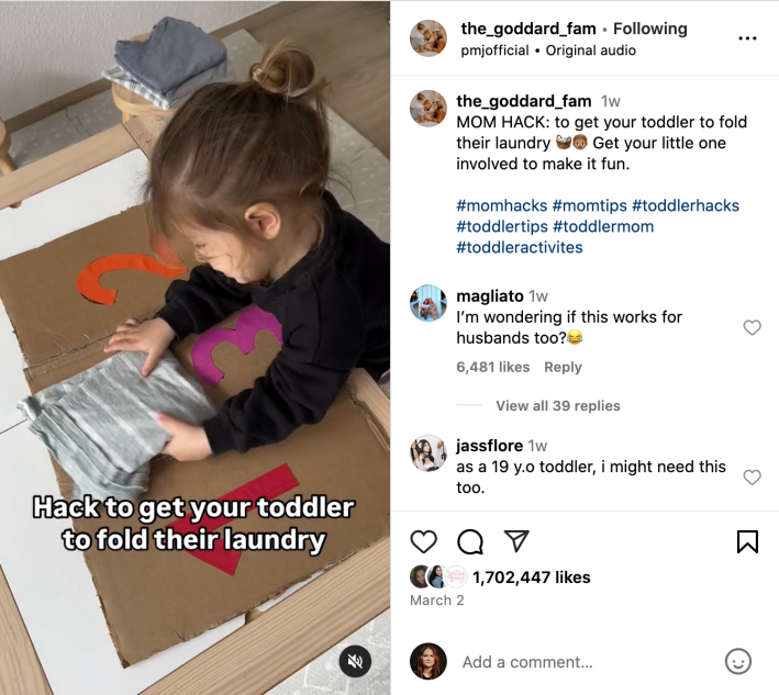 An instagram reel of a toddler folding laundry using a cardboard folding contraption