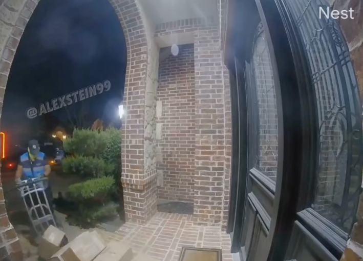 An amazon worker leaving a pile of boxes on a front step offhandedly