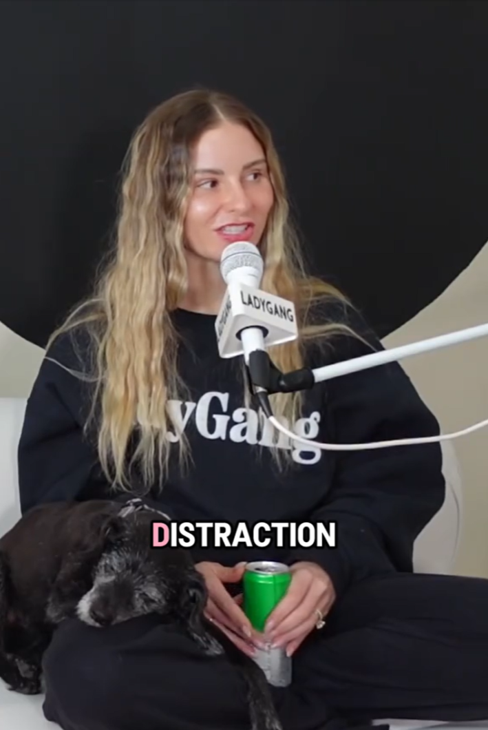 Floodlighting - Woman on a podcast with an elderly dog sleeping on her leg. "Distraction" is in the text overlay.
