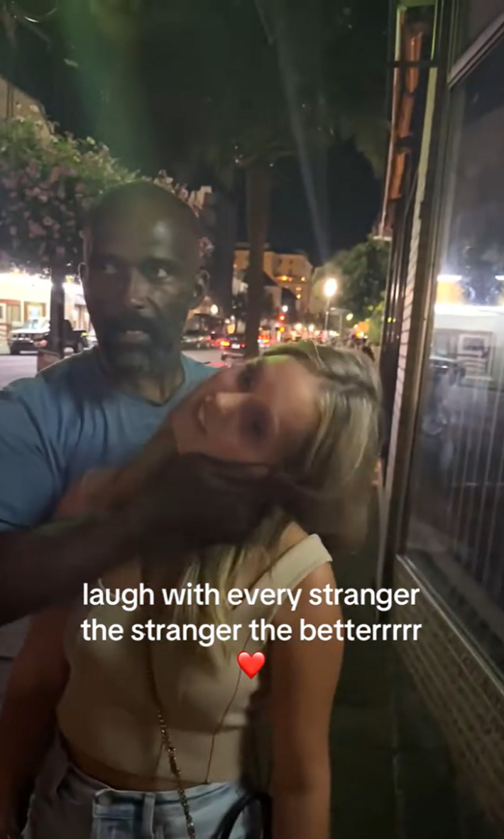 Laugh with every stranger trend, a man cracking a woman's neck on the street.