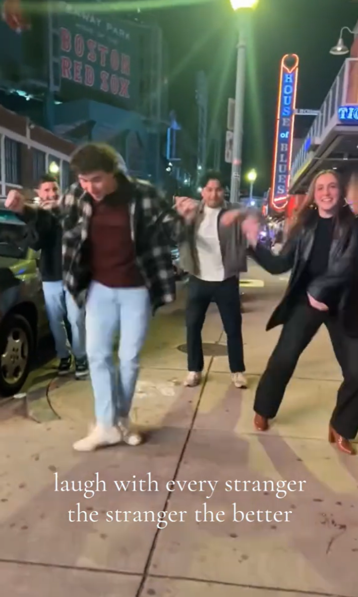 Laugh with every stranger trend of a group of people dancing in the street.