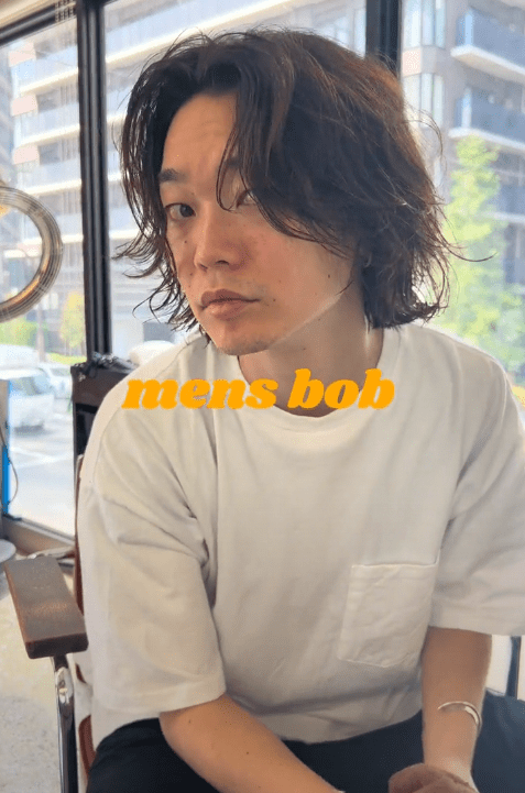 TikTok video with a man showing off his men's bob hairstyle.