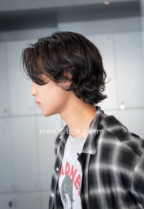 TikTok video with a man in a flannel shirt showing a side view of his men's bob perm.