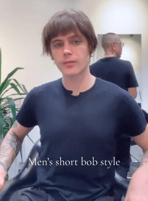 TikTok video of a young man in a barber's chair with a fresh men's bob hair cut.