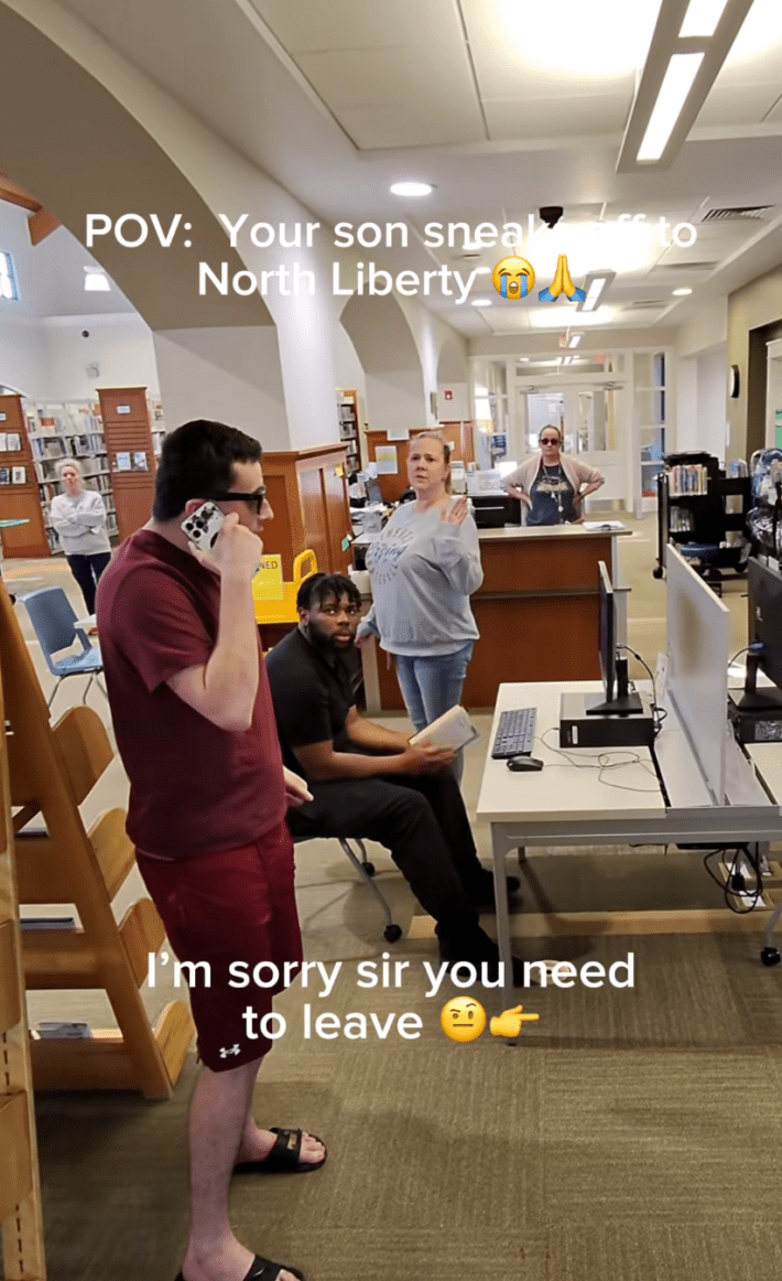 North Liberty meme trend TikTok with a man pretend-borrowing someone's phone to fake-yell at their 'son' in the middle of a library. Text reads, "POV: Your son sneaks off to North Liberty. / I'm sorry sir you need to leave."