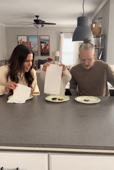 Cookie share prank TikTok video with a child lifting up her paper towel to reveal two cookies.