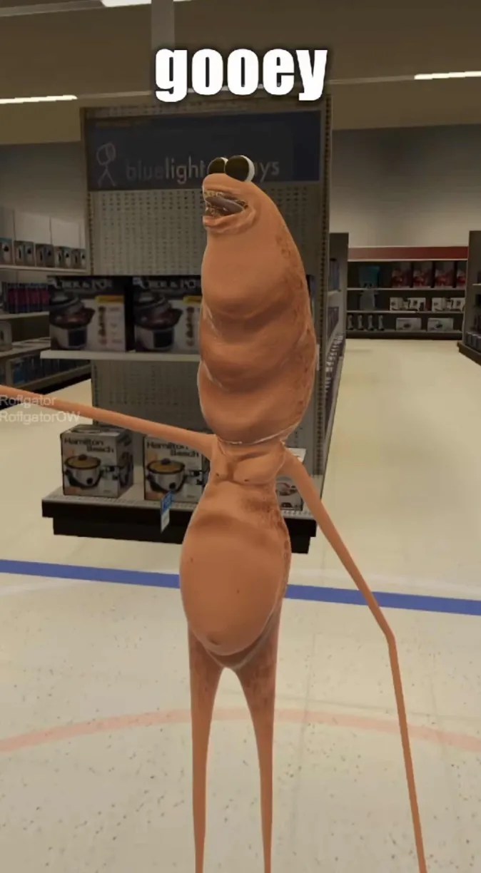 Screenshot of Marcus the worm saying, "gooey" while pointing off screen.