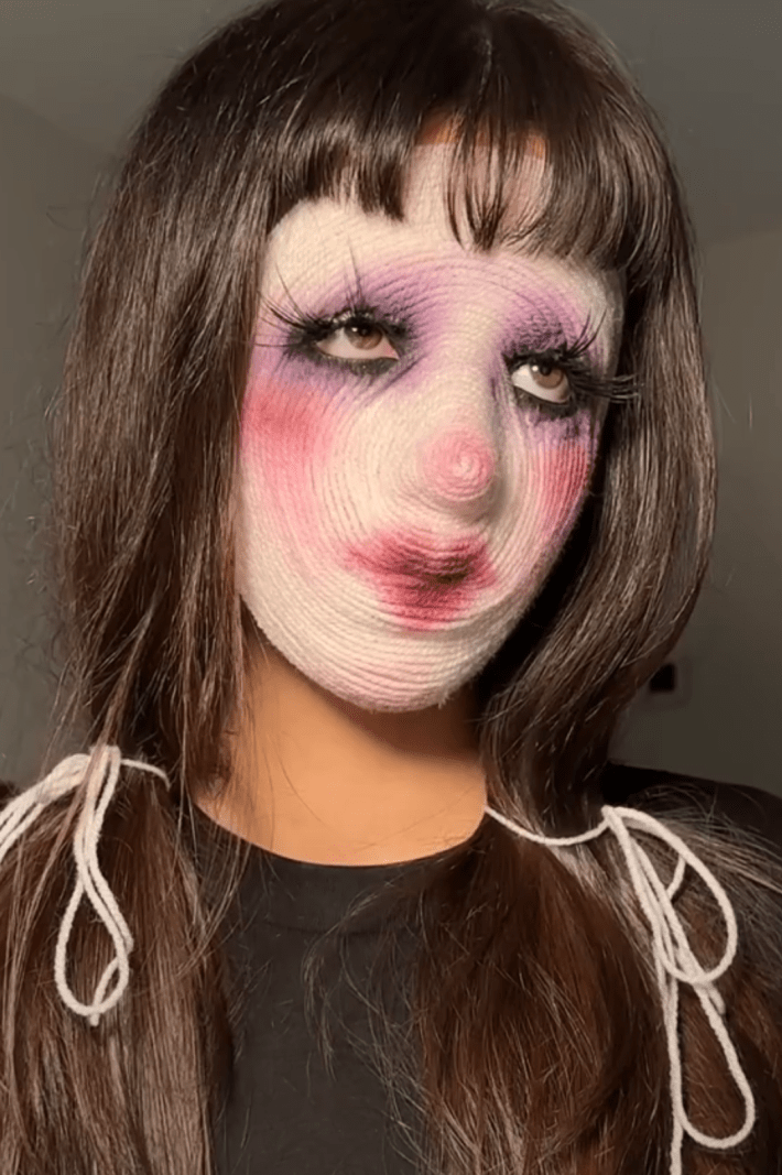 A woman performing the yarn makeup trend