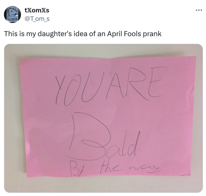 Tweet that says, "This is my daughter's idea of an April Fools prank" with a pink sticky note that reads, "You are bald by the way."