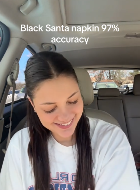 Black Santa Napkin meme TikTok accuracy reenactment video with a woman laughing in her car.