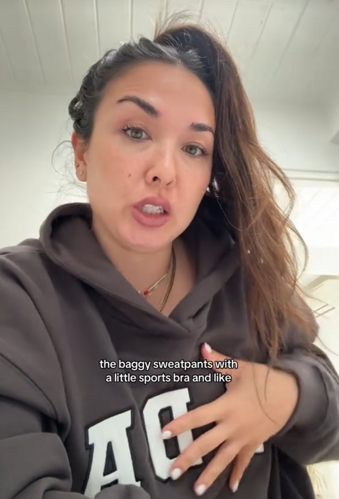 Gen Z vs Millennial gym wear TikTok video showing a woman talking to the camera and touching her chest.