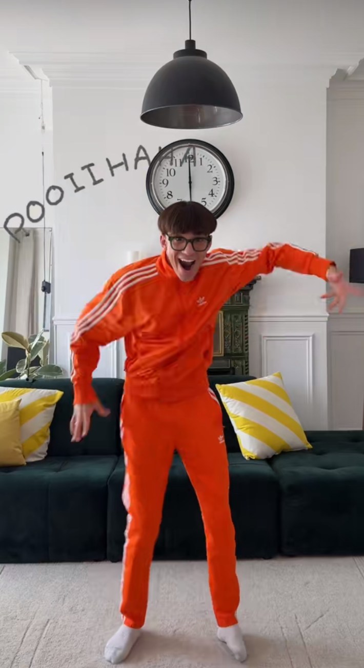 Man in a bowl haircut and bright orange tracksuit dancing to Le Poisson Steve.