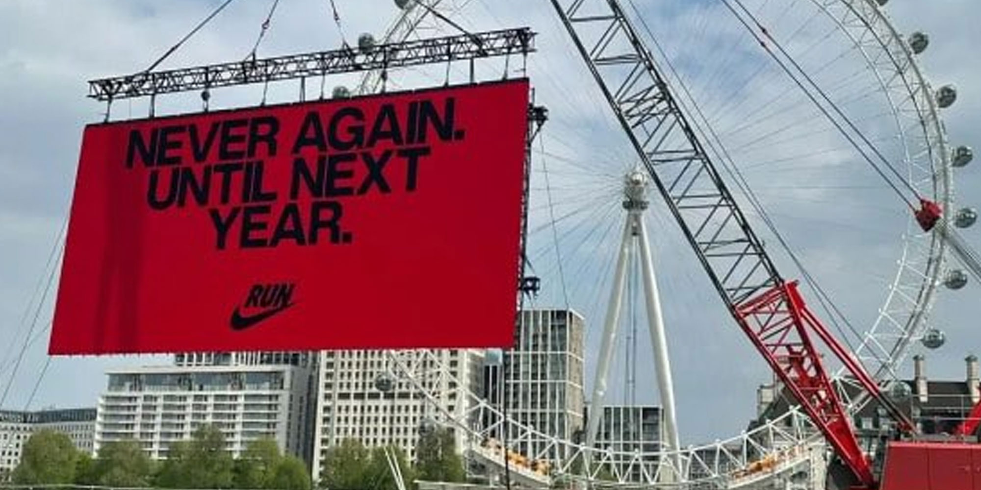 Photo from X user @Ostrov_A of a sign in front of the London Eye that reads "Never Again. Until Next Year."