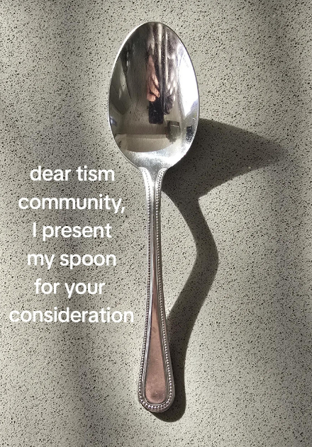 TikTok spoon rating video showing a silver spoon with a ridged handle that flares at the end.