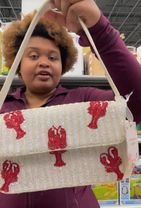 TikTok video of a woman showing a lobster beaded bag to the camera.
