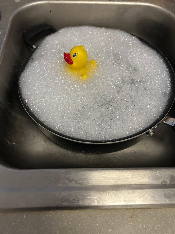 Photo of a rubber ducky in a "sad bath" pan.