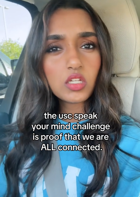 TikTok video of a woman singing to the camera with a caption reading "the usc speak your mind challenge is proof that we are ALL connected."