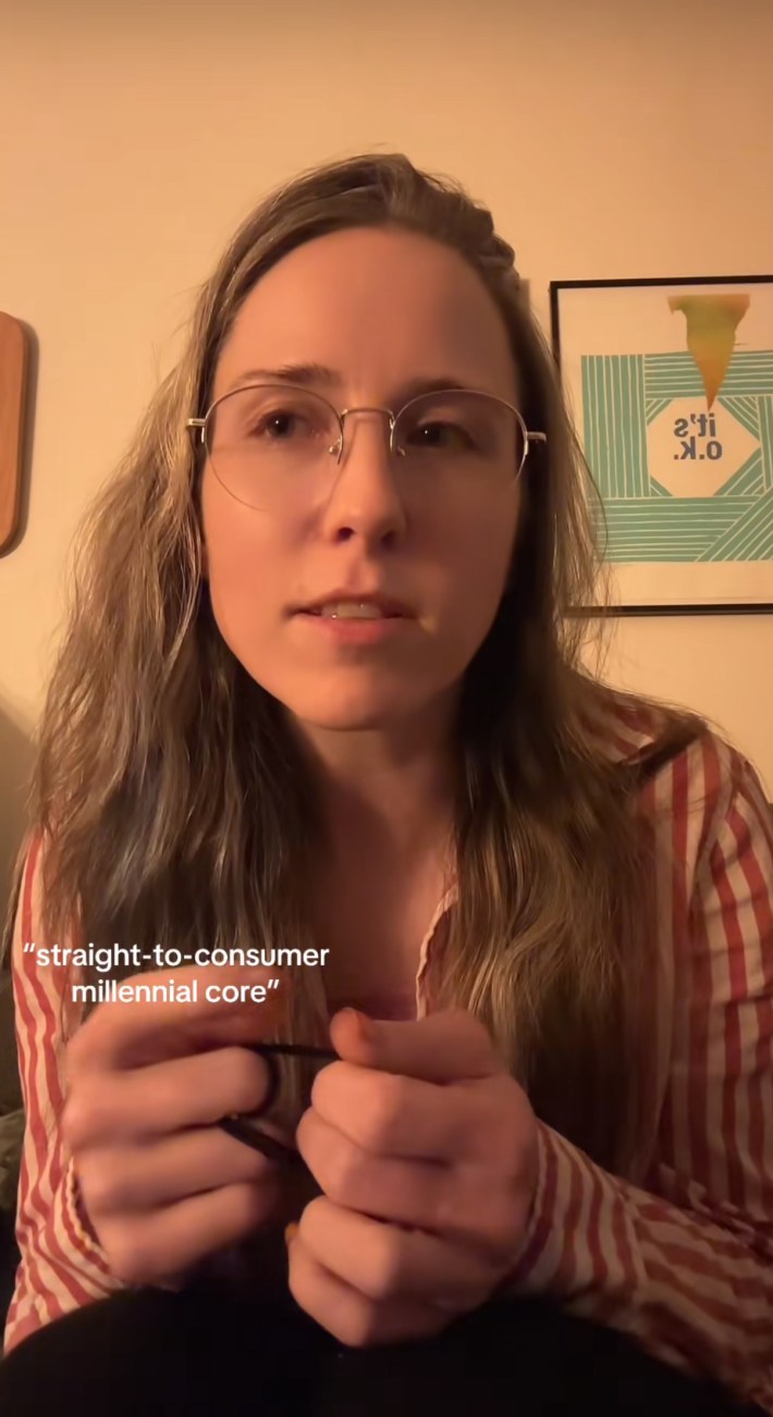 A woman talking to the camera saying, "straight to consumer Millennial core."