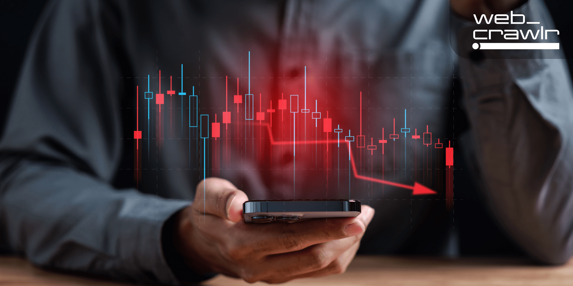 A person holding a phone with a display of a graph descending. The Daily Dot newsletter web_crawlr logo is in the top right corner.