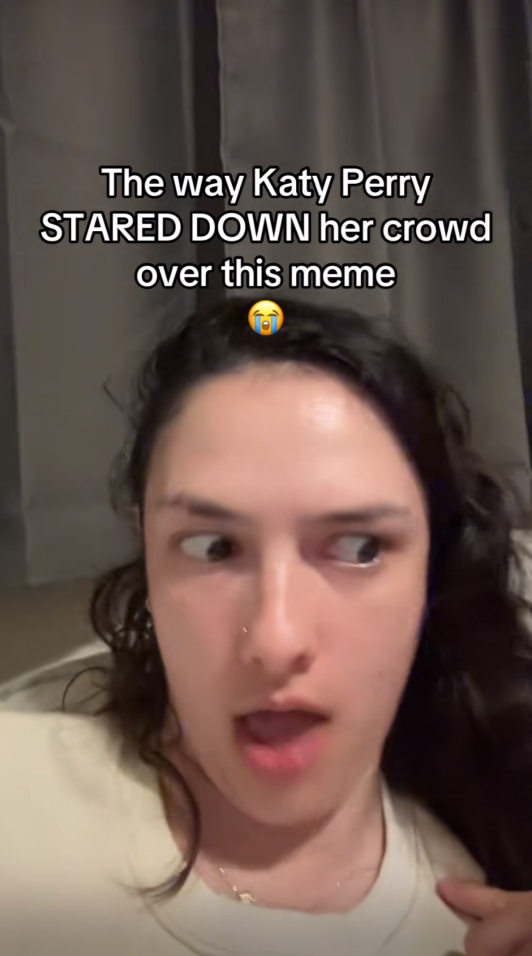 TikToker over-enunciating a Katy Perry song. Text overlay reads, "The way Katy Perry STARED DOWN her crowd over this meme (sob emoji)"