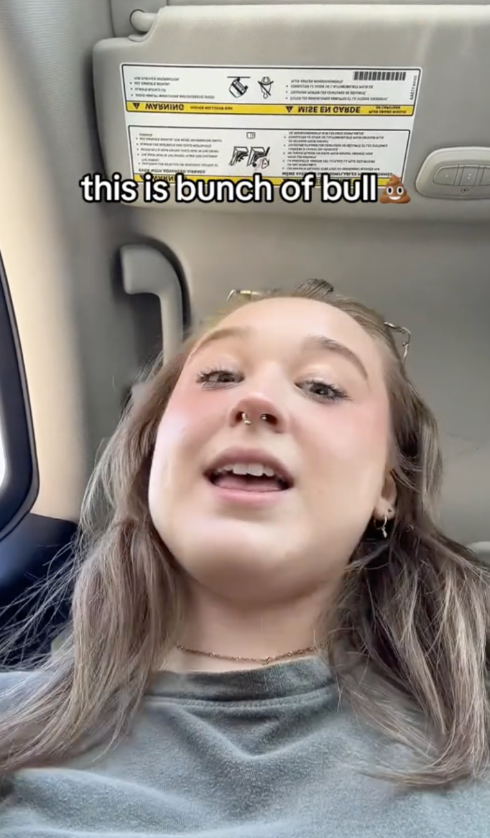 User @lil_tachy on TikTok looking into the camera as a man berates her for using a wheelchair