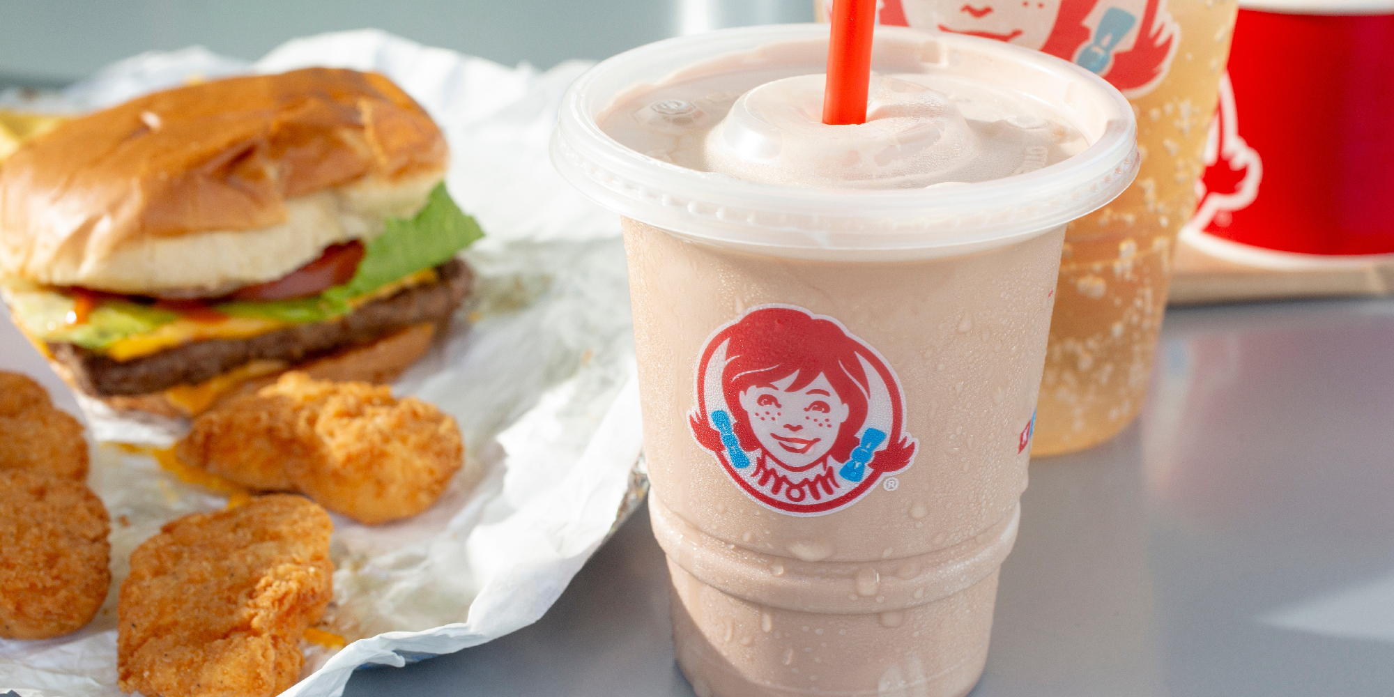 Photo of common meal at Wendy's restaurants with a Frosty, cheeseburger and chicken nuggets.
