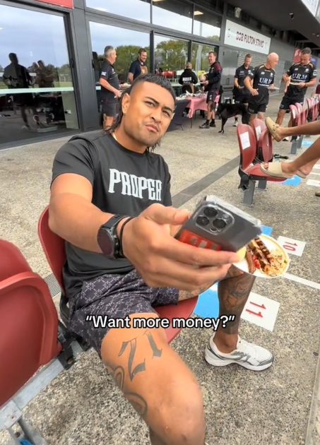 TikTok video of a man holding out his phone and saying "Want more money?"