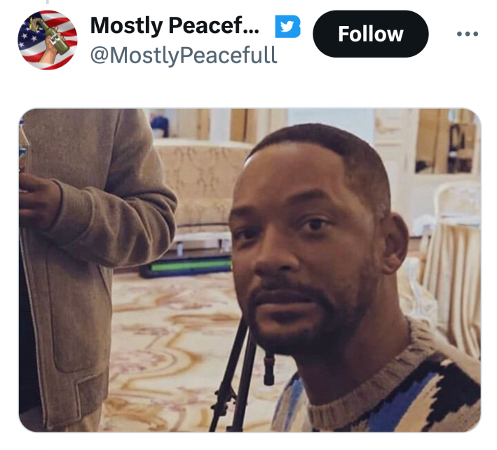 Tweet that shows an image of Will Smith grimacing into the camera.