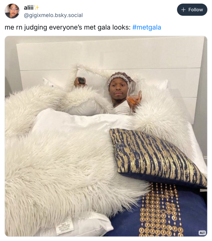 Post that reads, "me rn judging everyone’s met gala looks:" with a photo of a Black man with a giant wine glass in a cozy plush bed.