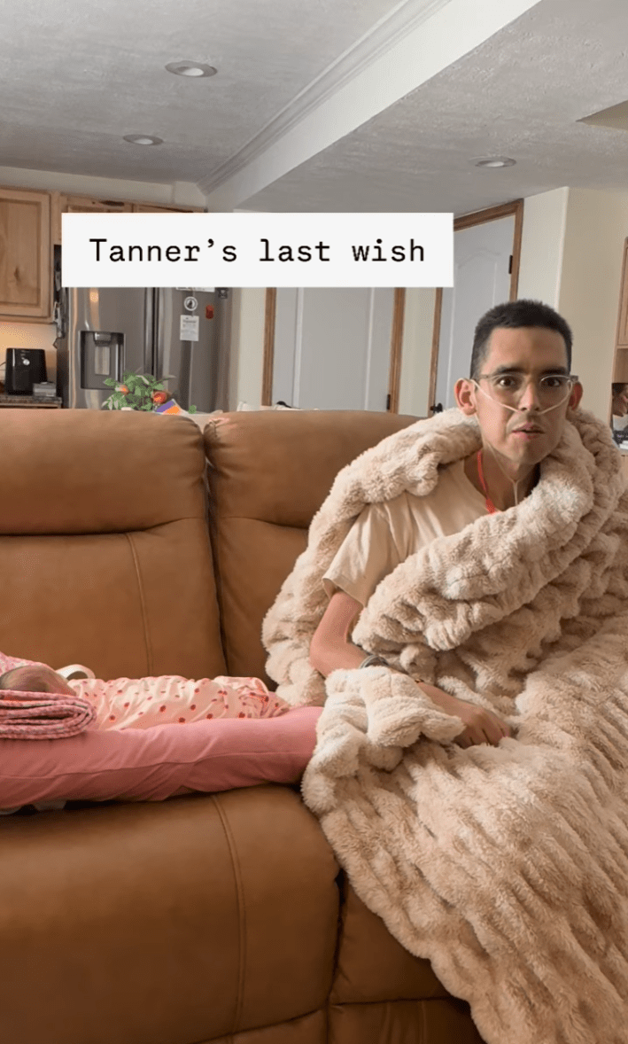 A terminally ill man wrapped in a plush blanket on the couch next to his newborn daughter. Text overlay reads, "Tanner's last wish."