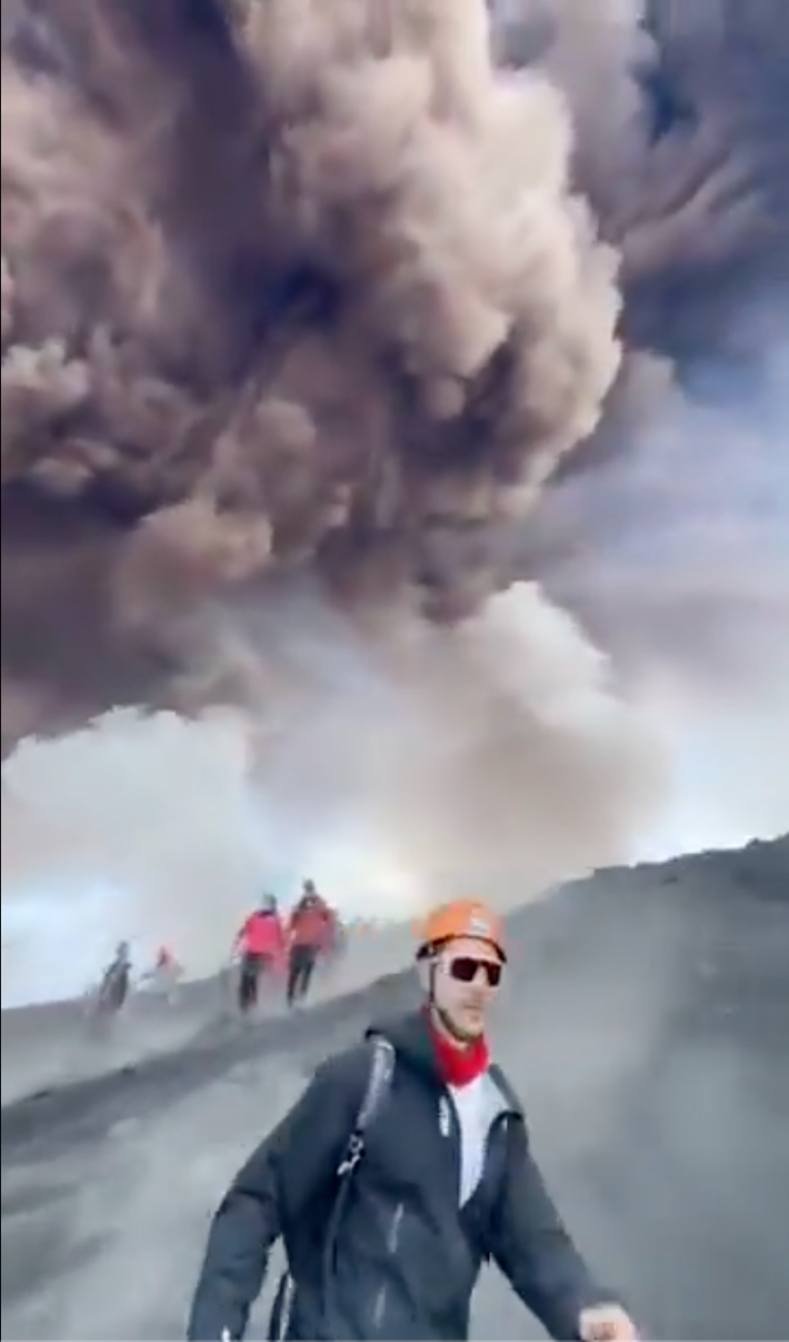 Screengrab of an erupting volcano while the tour group runs away.